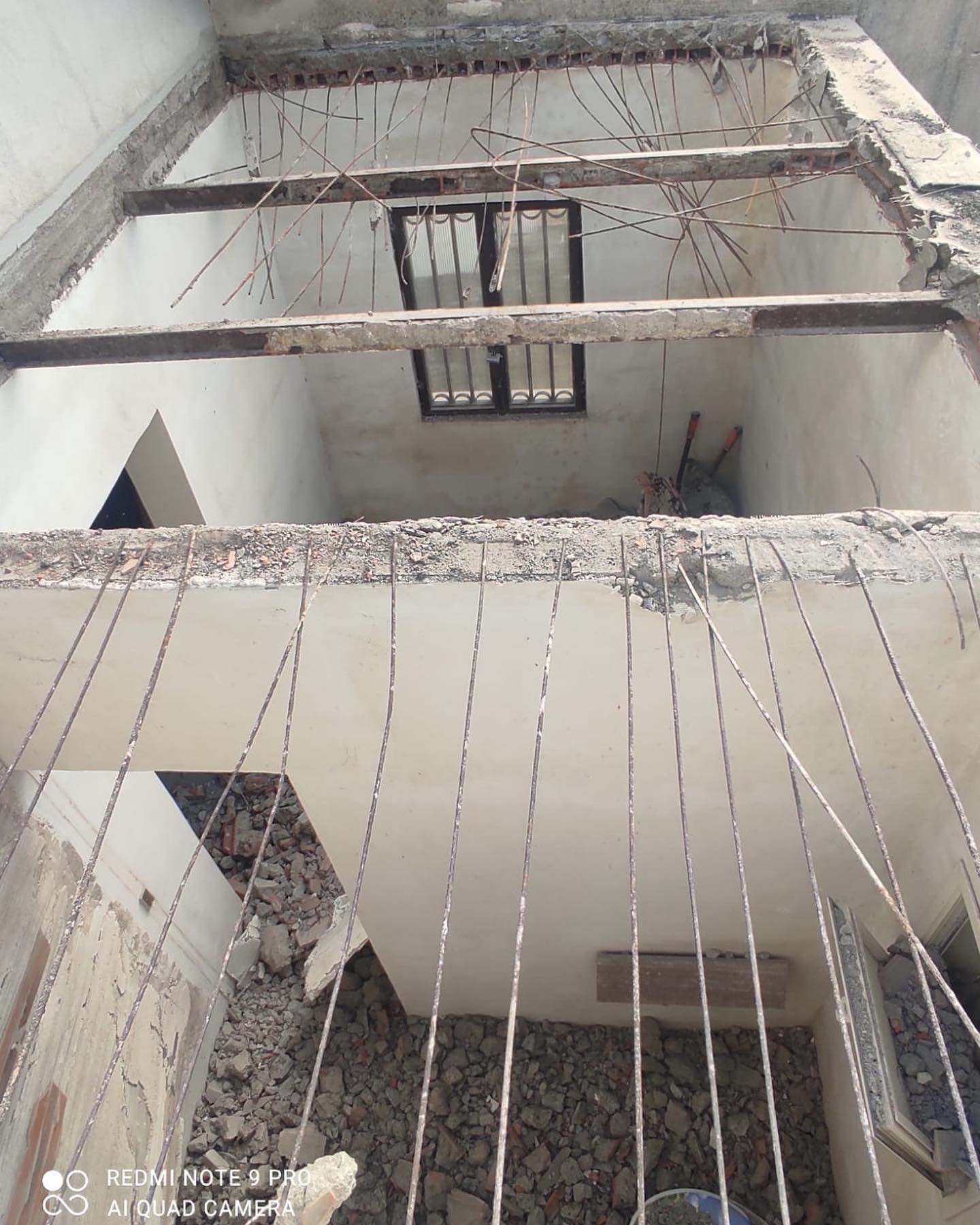 Looking up through the opened floors, the old structure laid bare to the sky